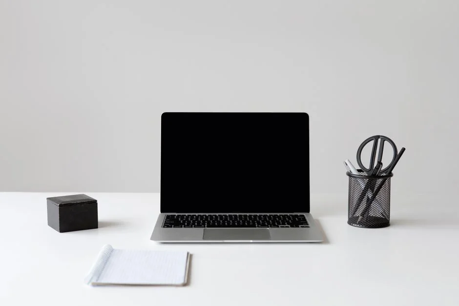 Overhead shot of two colleagues collaborating with devices and notes in a business meeting.